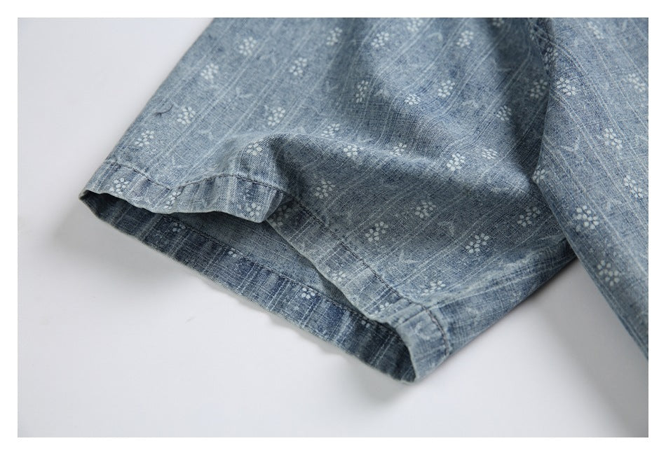 Close-up of the blue patterned shirt's short sleeve and stitched hem.