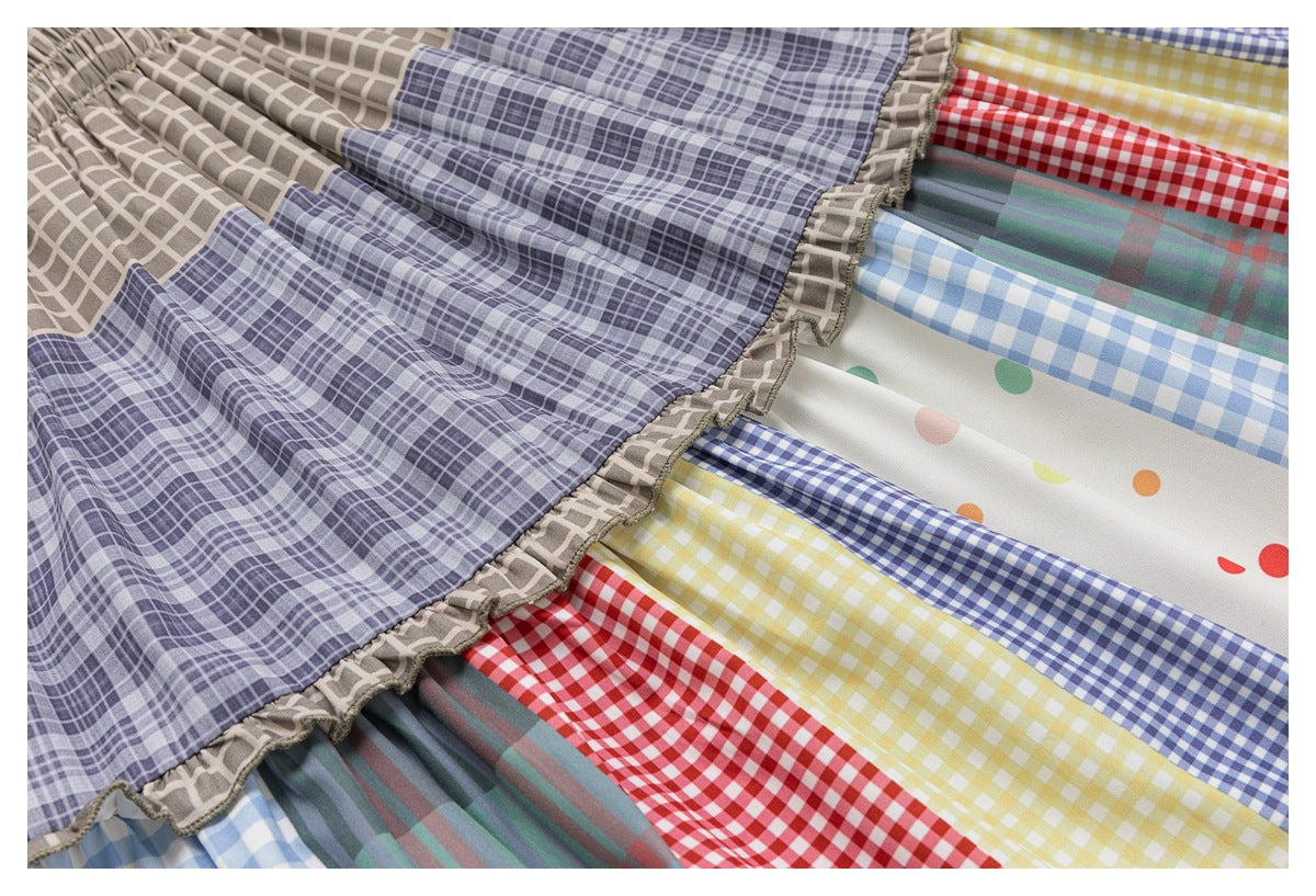 Close-up showing the skirt's ruffled tier seam and colorful plaid, gingham, and polka-dot panels.