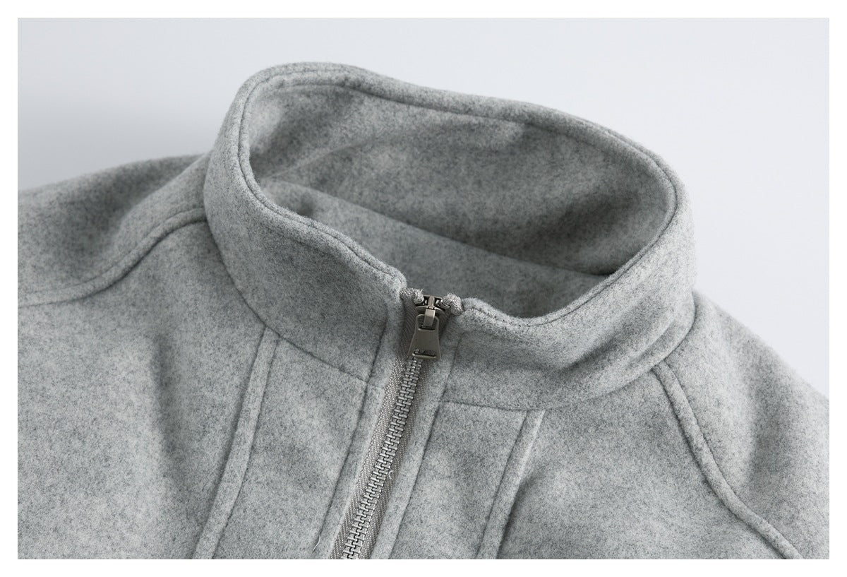 Close-up of the jacket's raised collar, front zipper, and curved shoulder seams.