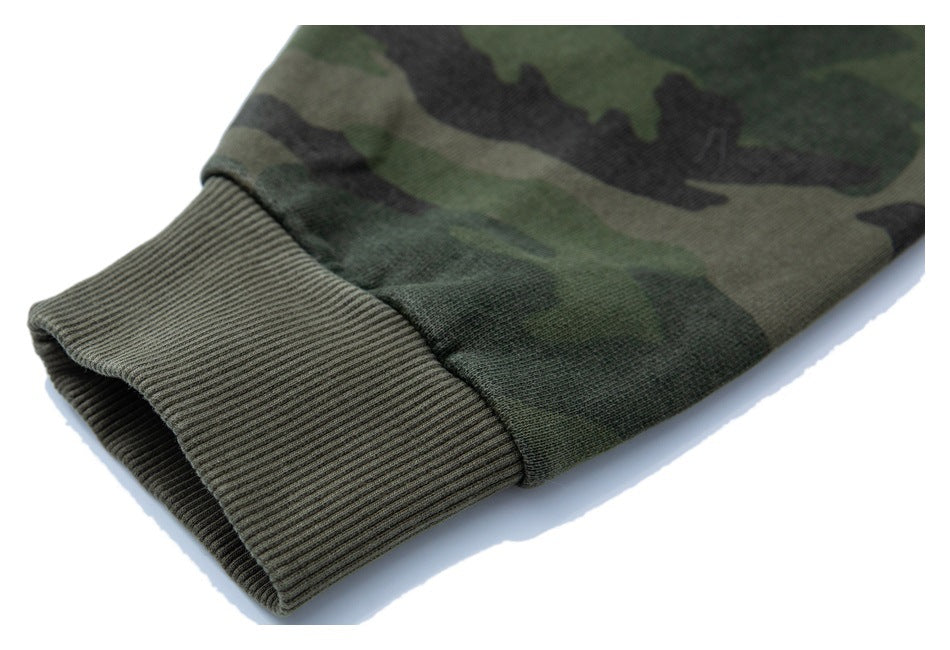 Close-up of a ribbed olive cuff on a green camouflage sleeve.