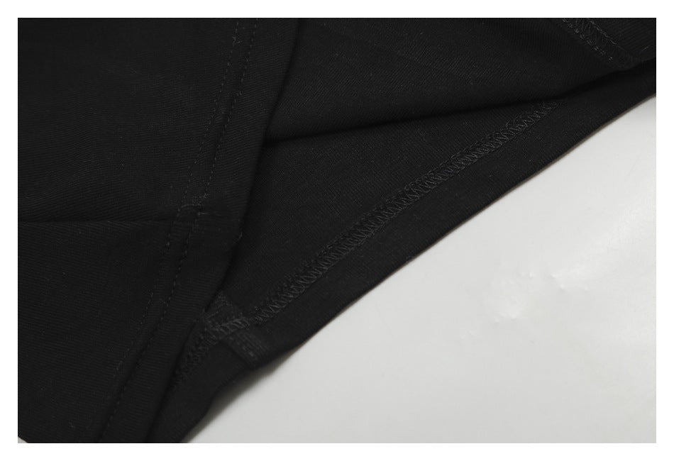 Close-up of interior seams and overlocked stitching on black fabric.