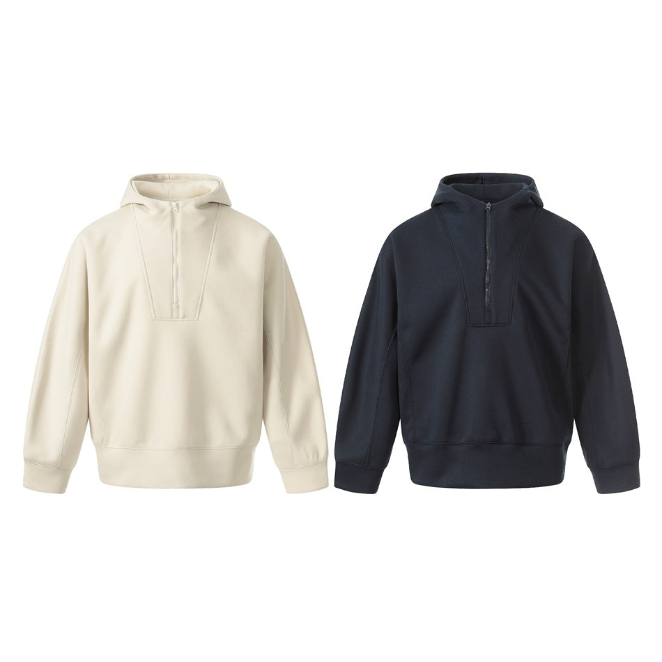 Two front views of a hooded pullover with a short zipper, shown in ivory and dark navy.