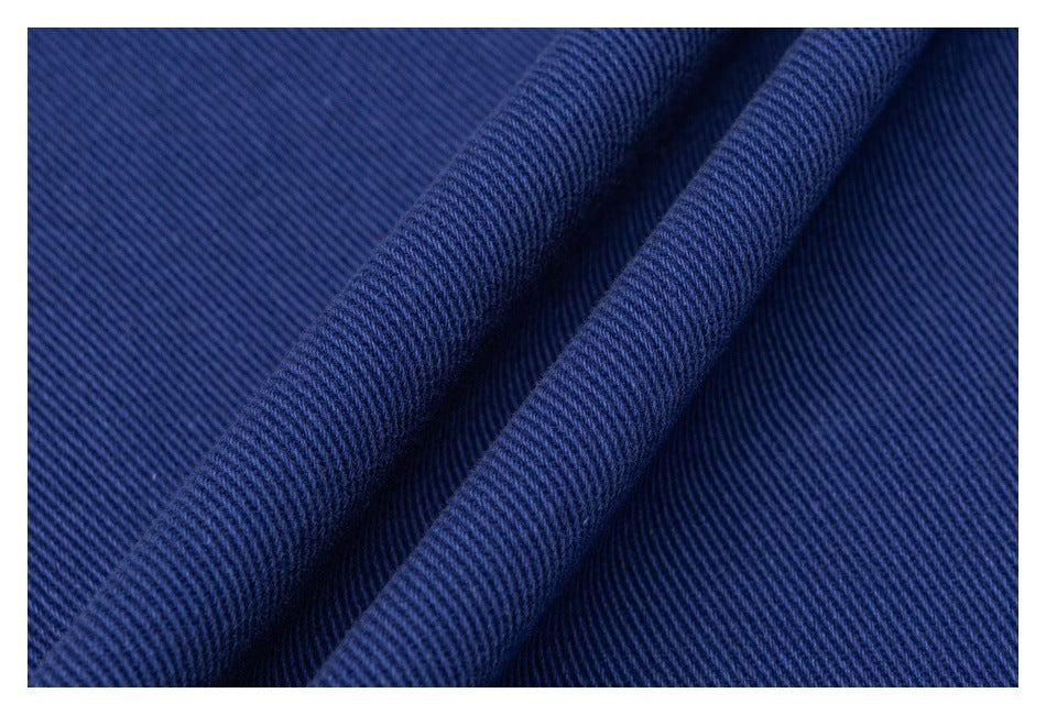 Close-up of dark blue fabric with a fine diagonal ribbed texture and soft folds.