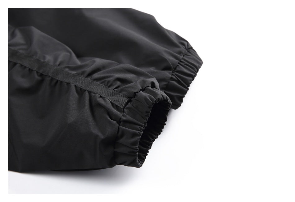 Close-up of black garment fabric with gathered elastic edges and a narrow trim.