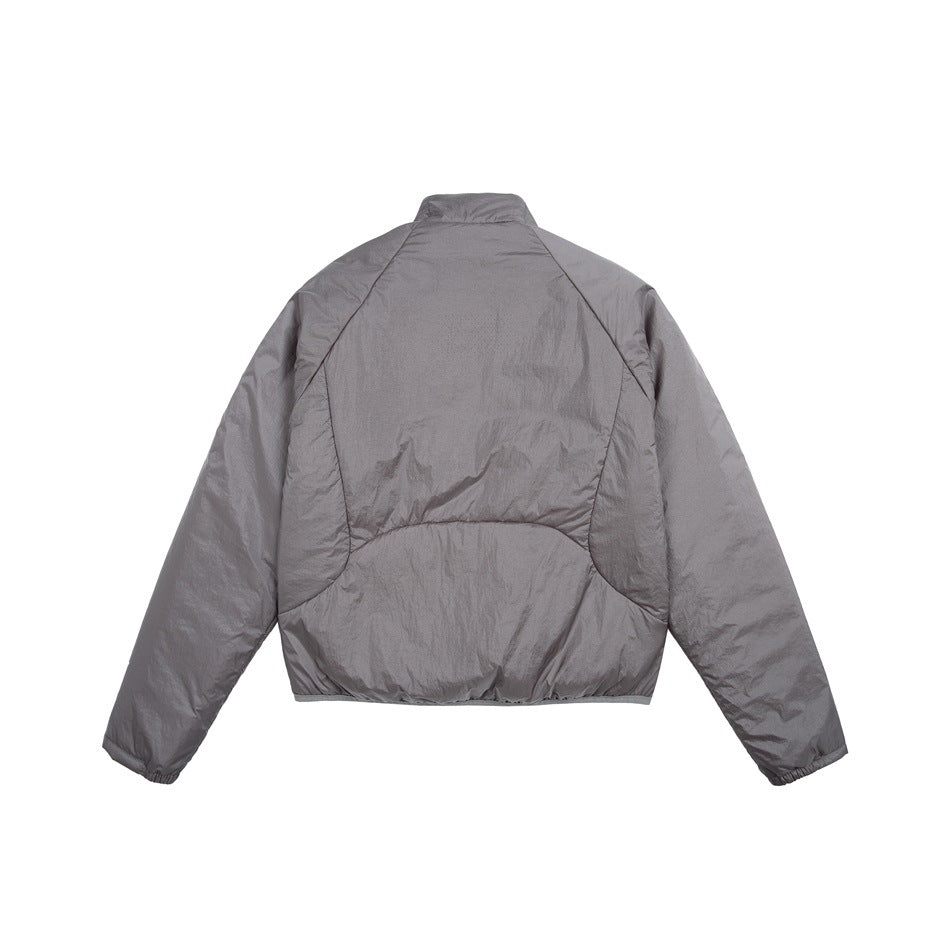 Back view of a gray jacket with a stand collar, curved panel seams, and elasticated cuffs.