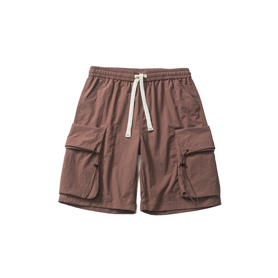Reddish-brown cargo shorts front flat lay with off-white drawstring and two large flap pockets with toggle cords