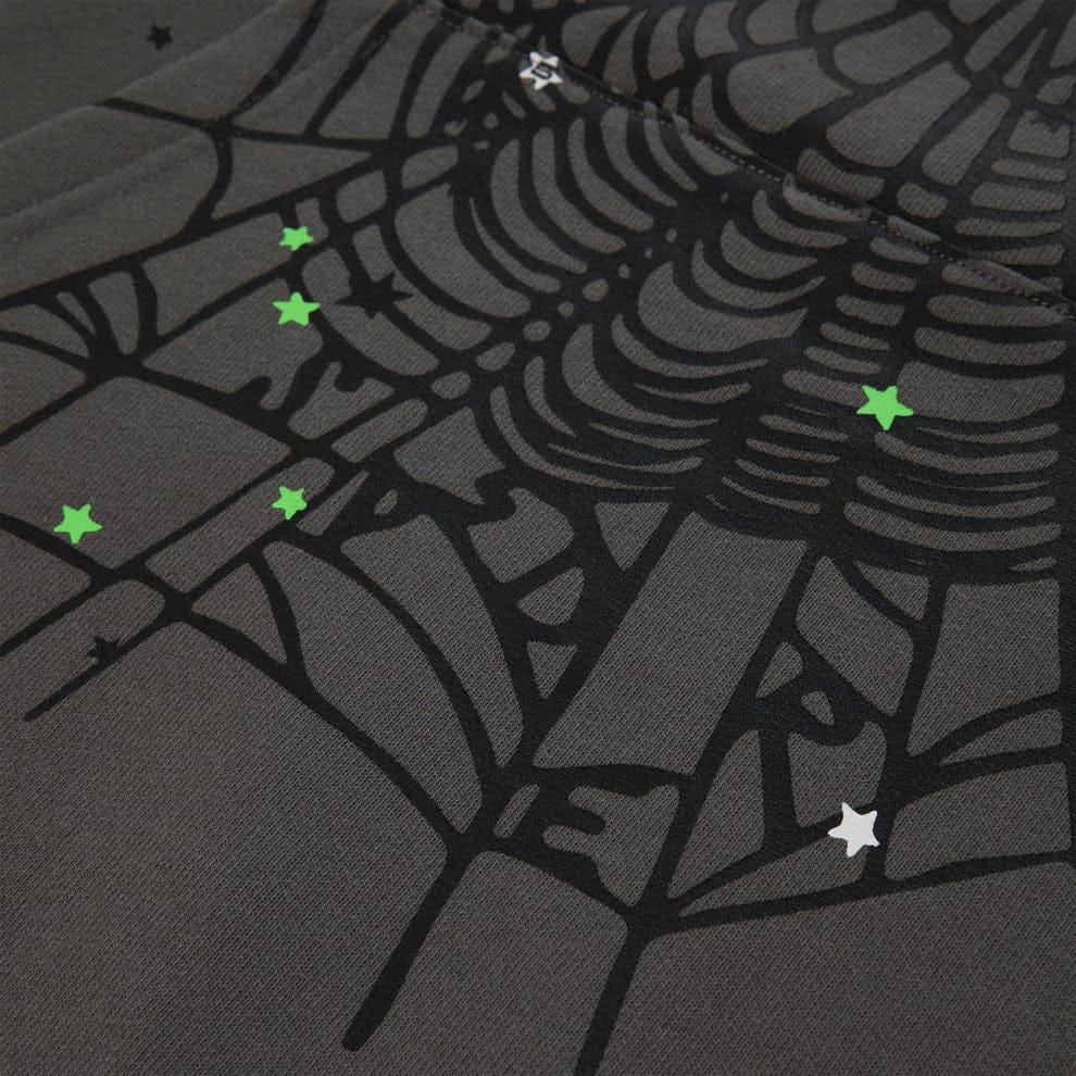 Close-up of the Sp5der “P!nk! Hares the Slime” Hoodie—a heavyweight olive green pullover with a bold spiderweb and green and white star accents, inspired by iconic streetwear style.