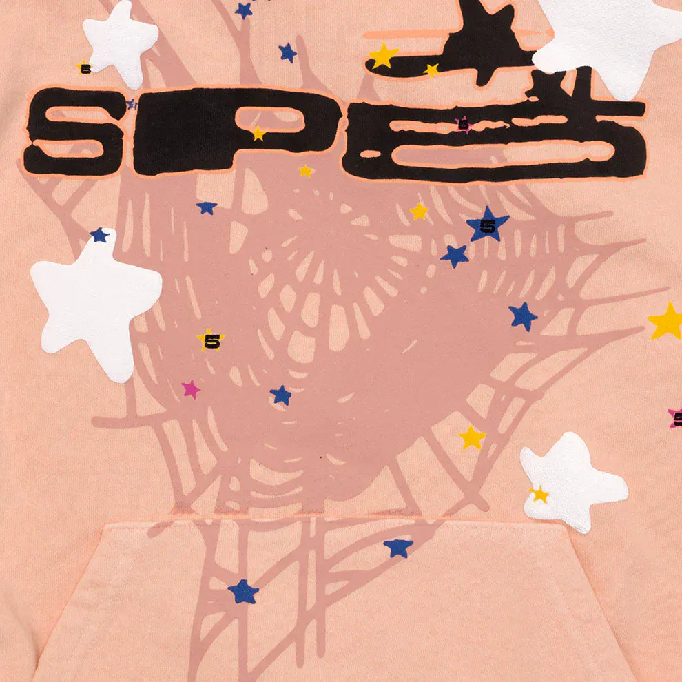 The Sp5der Star Web Hoodie – Peach Pink 440GSM Heavyweight Oversized Streetwear Pullover features a spiderweb print, colorful stars, and bold "SPE" text—perfect for Y2K-inspired streetwear vibes.