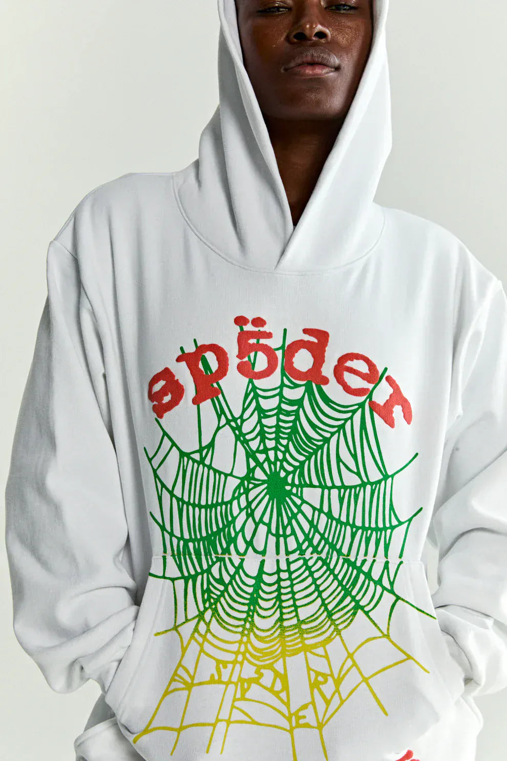Wearing the Sp5der “Toxic Web” Hoodie – White & Neon Lime 440GSM Heavyweight Oversized Pullover, featuring a red "spider" logo above a green and yellow web—a bold Y2K streetwear essential.