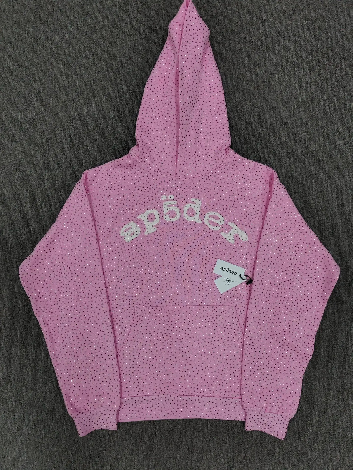 Pink Sp5der hoodie with all-over rhinestone detailing and arched Sp5der logo on the front