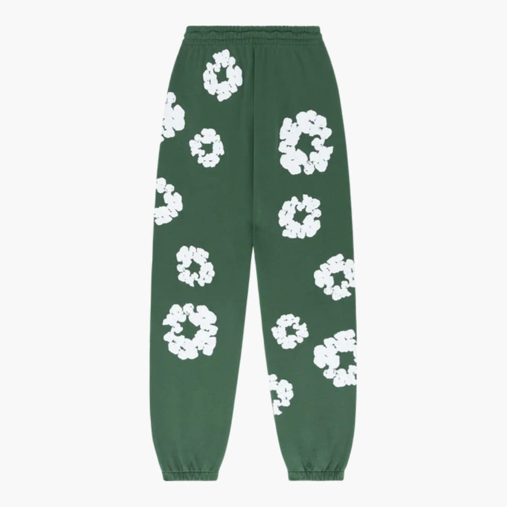 Forest Green “Cotton Wreath” Denim Tears Sweatpants featuring an elastic waistband, cuffs, and bold white floral print inspired by a cotton wreath.