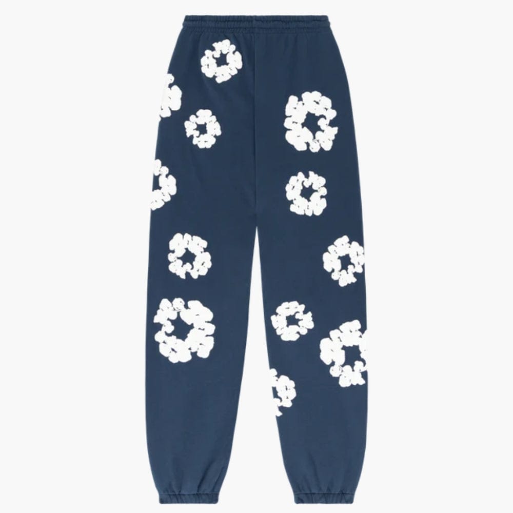 Navy Blue “Cotton Wreath” Denim Tears Sweatpants with white floral print, inspired by the iconic cotton wreath motif and featuring streetwear style.