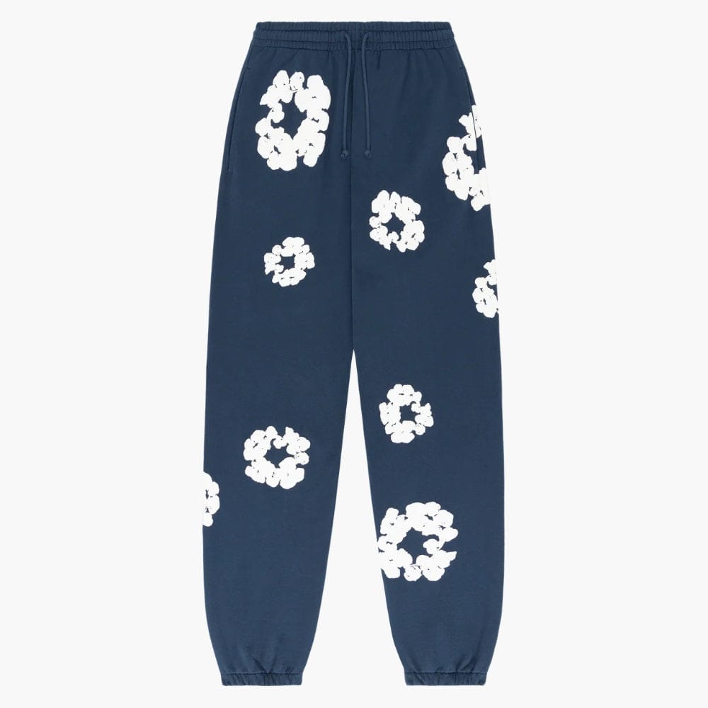 Navy Blue “Cotton Wreath” Denim Tears Sweatpants featuring white floral print, an elastic drawstring waistband, and elastic cuffs inspired by the signature cotton wreath motif.