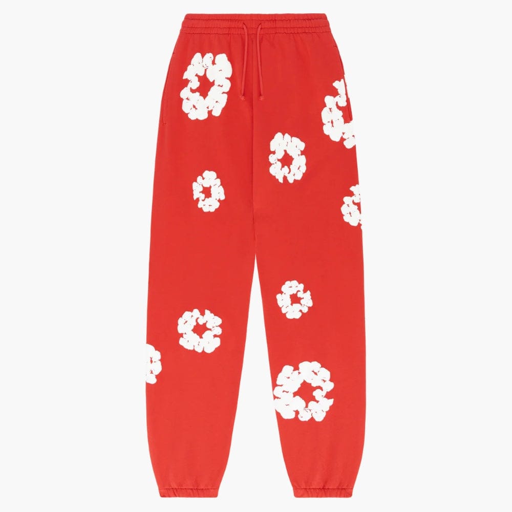 Red “Cotton Wreath” Denim Tears Sweatpants feature white floral prints, an elastic waistband and cuffs—these standout streetwear pants are a must-have for bold style.