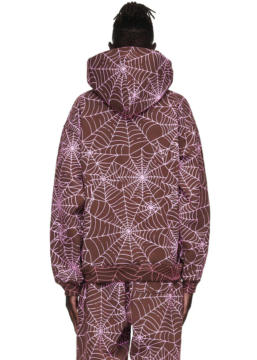 A person facing away, wearing the Brown All-Over Spider Web Graphic Hoodie – a comfort-fit pullover featuring a pink spider web print.