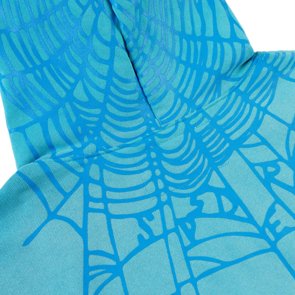 Close-up of the Turquoise Graphic Hoodie with Star Detail, showcasing a darker blue spider web back print and a visible vertical seam for added depth and unique style in this comfort fit pullover hoodie.