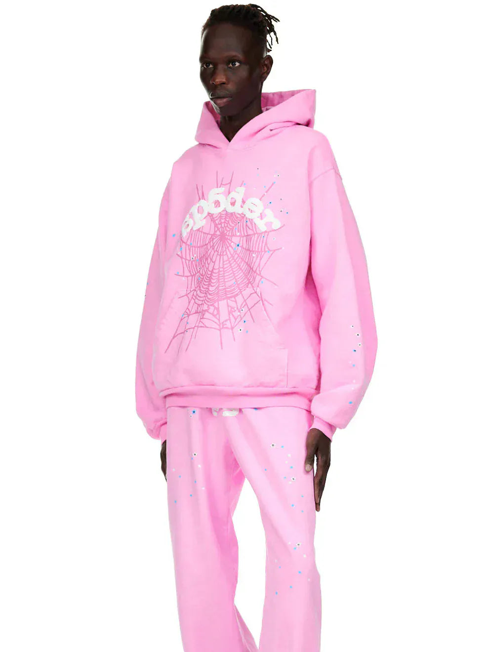 A person wears a Pink Graphic Hoodie with Spider Web Print – Comfort Fit Pullover Hoodie and matching pink pants, standing against a plain white background.