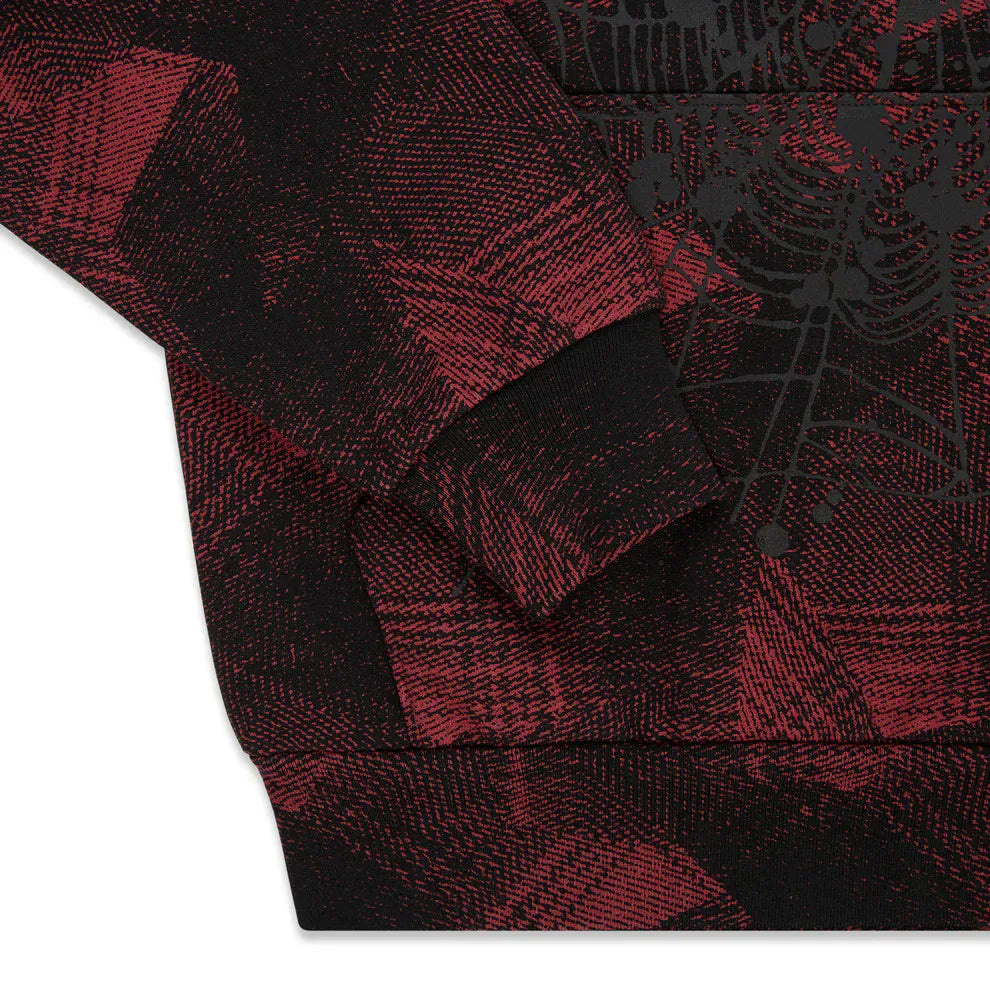 Close-up of the Red and Black Graphic Hoodie with Star Detail and Spider Web Print, a comfort fit pullover with long sleeves and ribbed cuffs—ideal for streetwear fans seeking a unique graphic hoodie.