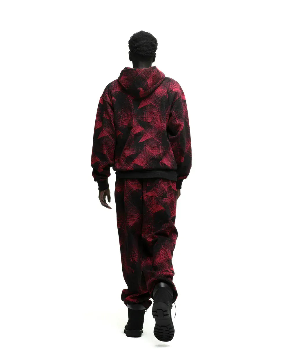 A person wears the Red and Black Graphic Hoodie with Star Detail and Spider Web Print – a comfort fit pullover – facing away from the camera on a white background, showcasing bold modern streetwear style.