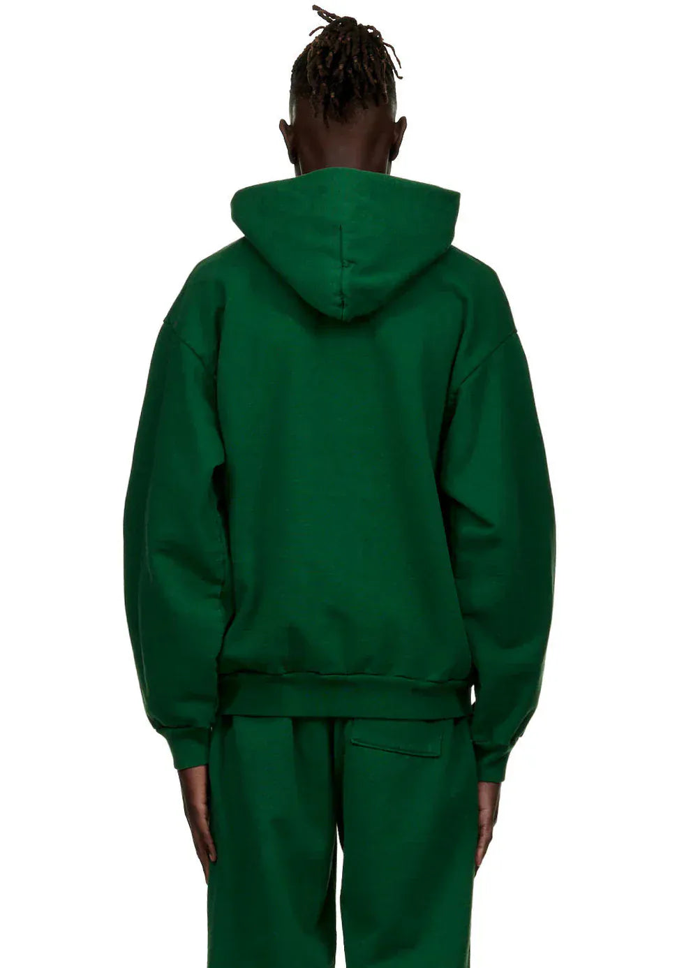 A person stands with their back to the camera, wearing a Dark Green Graphic Hoodie with Spider Web Print – a comfort fit pullover for everyday wear – and matching green pants against a plain white background.