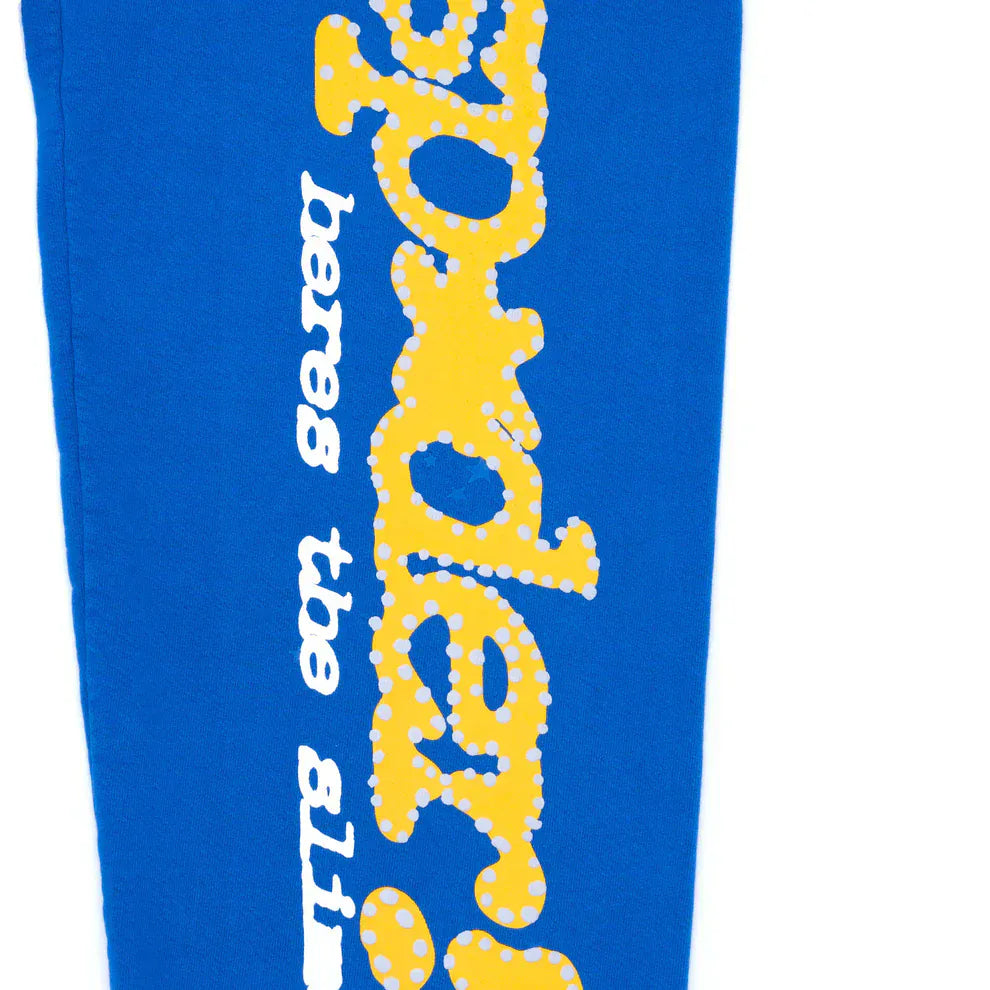 Sp5der Sweatpants are unisex blue cotton sweatpants featuring a yellow side logo and star print—ideal for streetwear or casual wear.