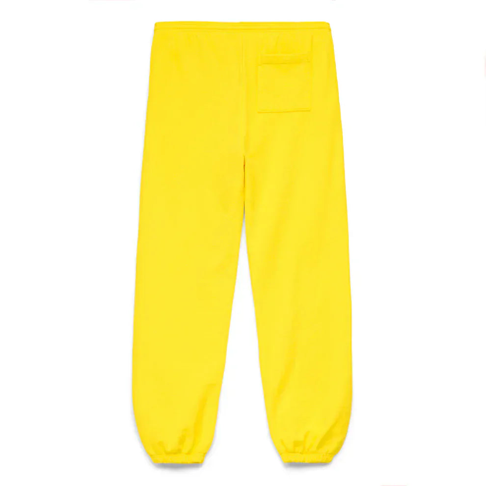 The Sp5der Sweatpants are unisex yellow cotton joggers with a front logo print, elastic waistband and cuffs, and a single back right pocket. They are shown laid flat on a white background.