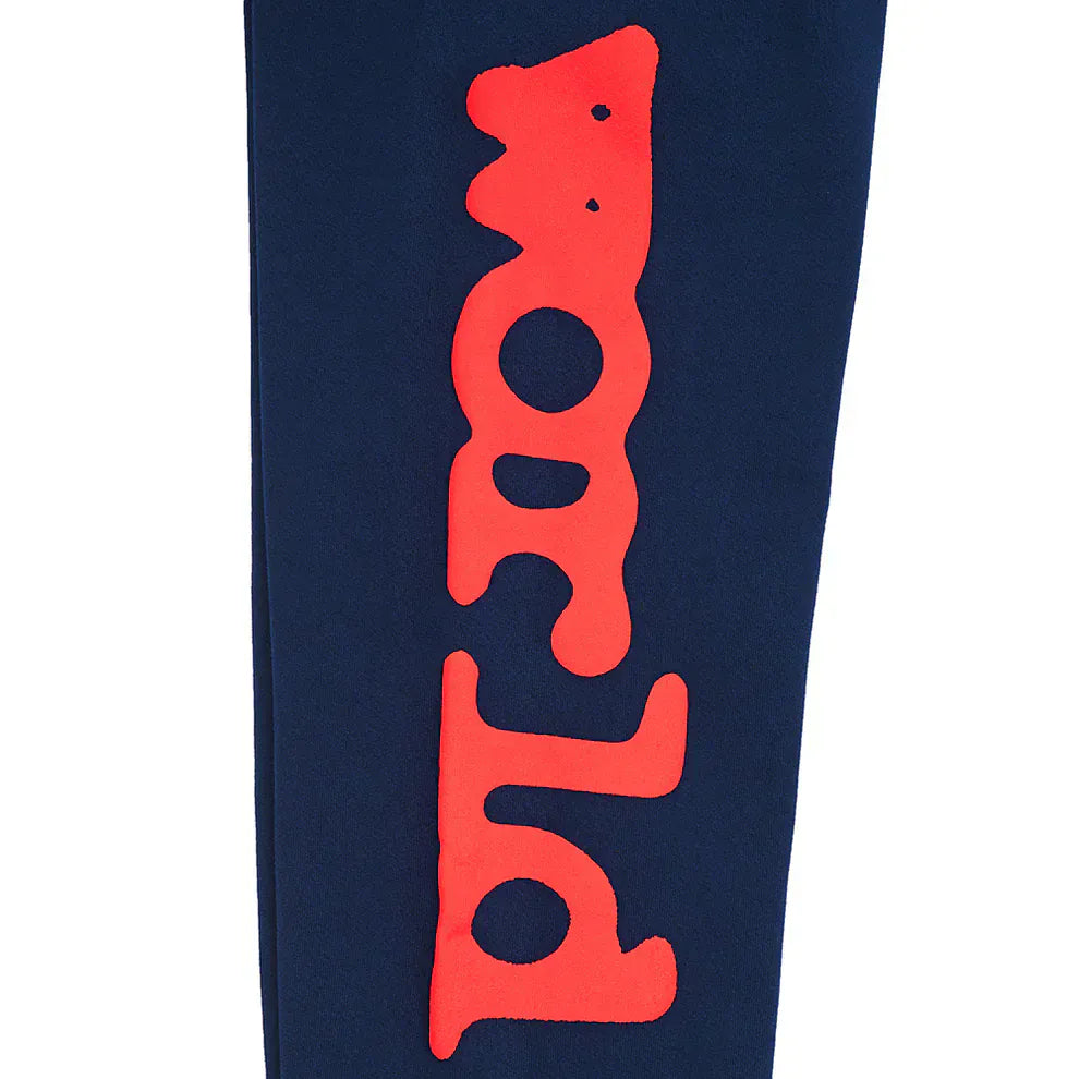 The Sp5der Sweatpants Navy Blue Red Side Logo Print are 100% cotton jogger pants featuring bold streetwear style, thanks to red "world" lettering displayed vertically along the leg.