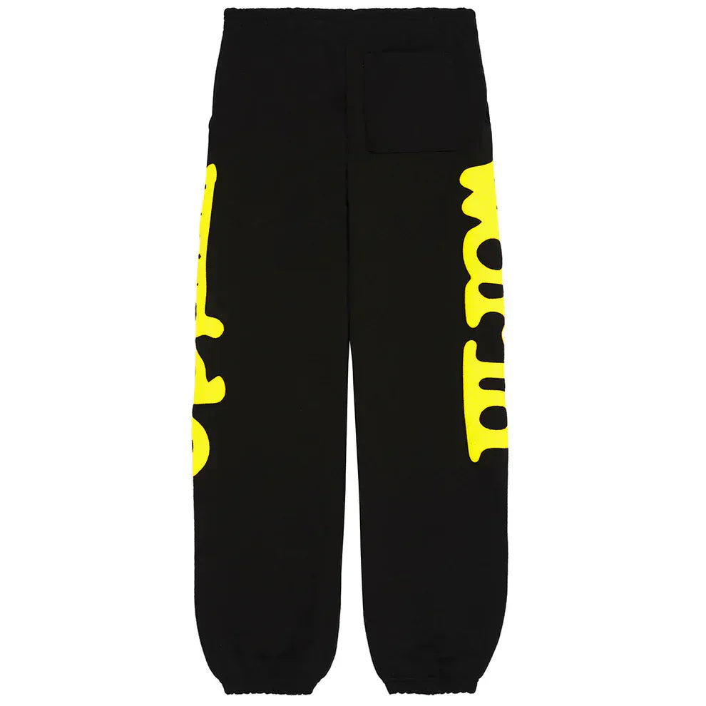 Sp5der Sweatpants Black Yellow Side Logo Print: 100% cotton streetwear jogger pants with elastic cuffs, a front right square pocket, and large yellow graphic text along both legs.
