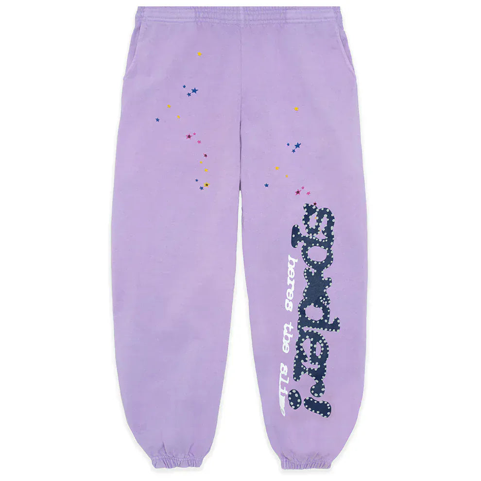 The 100% Cotton Sp5der Sweatpants are unisex lavender jogger pants featuring a relaxed fit, vertical logo, and star details—offering comfortable, stylish streetwear.