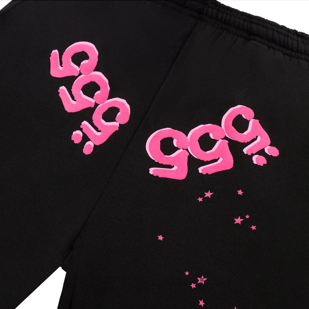 Close-up of unisex 100% Cotton Sp5der Sweatpants in black, featuring pink logo graphics—relaxed fit jogger pants for bold streetwear style.