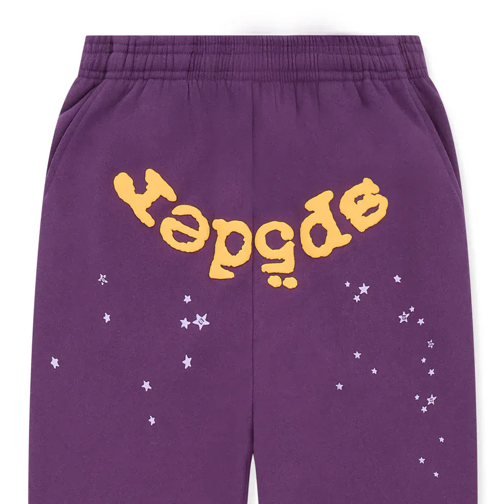 Unisex purple Sp5der sweatpants made from 100% cotton, featuring a yellow logo and star graphics in a relaxed fit.