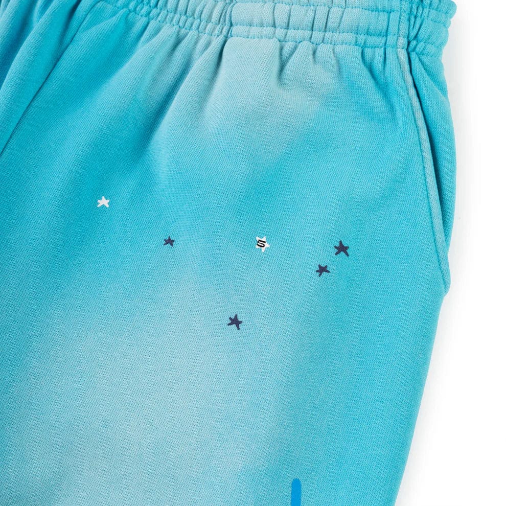 Close-up of 100% Cotton Sp5der Sweatpants—Unisex Blue Jogger Pants with a spider web graphic, star details, elastic waistband, and relaxed fit—ideal for streetwear lovers seeking standout style.