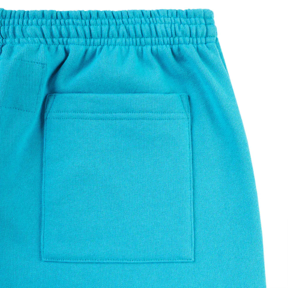 Close-up of 100% Cotton Sp5der Sweatpants—Unisex Teal Jogger Pants with a relaxed fit, elastic waistband, and orange logo print—perfect for streetwear.
