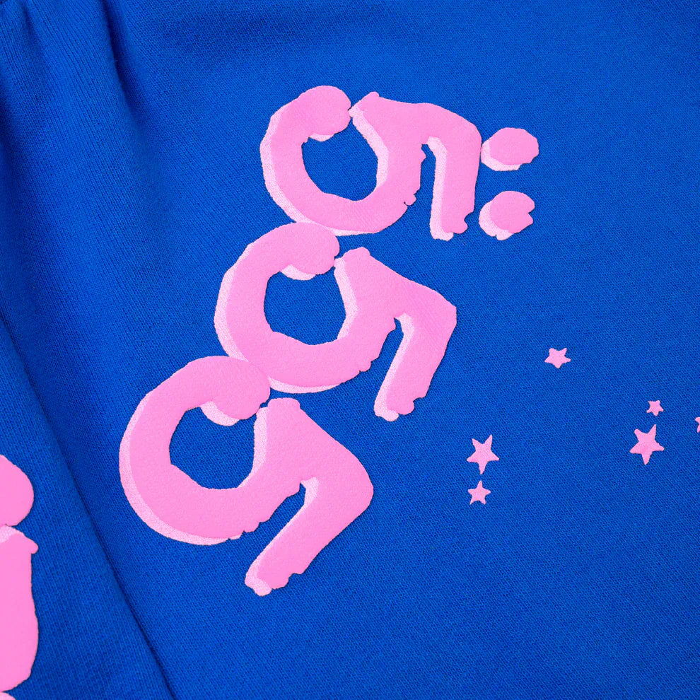 Close-up of 100% Cotton Sp5der Sweatpants—Unisex Blue Jogger Pants with pink logo and star accents, relaxed fit—perfect for streetwear lovers.