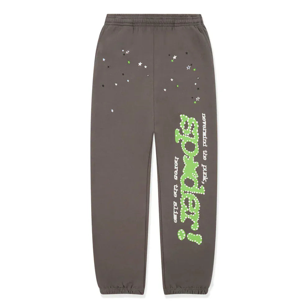 The Sp5der Sweatpants are unisex dark grey cotton joggers featuring green side logo details and white and green star prints, combining bold streetwear design with versatile comfort.