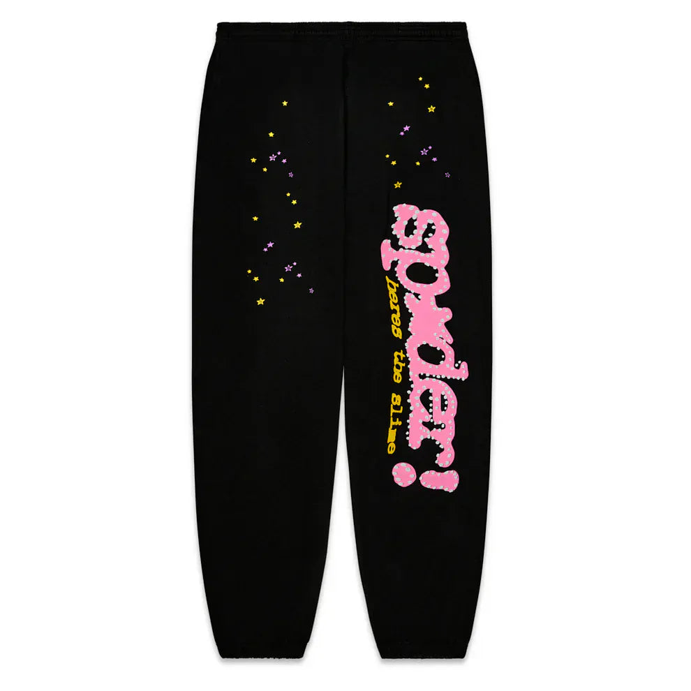 Sp5der Sweatpants – unisex black cotton sweatpants featuring colorful star prints, a bold pink “spider!” graphic logo, and yellow “never too late” text on the left leg—ideal for standout streetwear style.