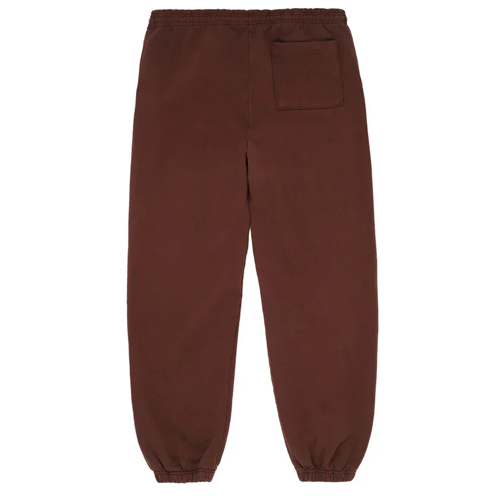 Unisex Sp5der Sweatpants in brown cotton, featuring a pink front logo and star print, shown laid flat with the back side up. Includes elastic waistband and cuffs, plus a single back pocket.