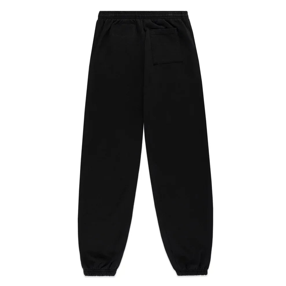 Unisex Sp5der Sweatpants in black cotton, shown from the back, feature a flame side logo, star print, elastic waistband and cuffs, plus a right-side back pocket—ideal streetwear joggers for a casual look.
