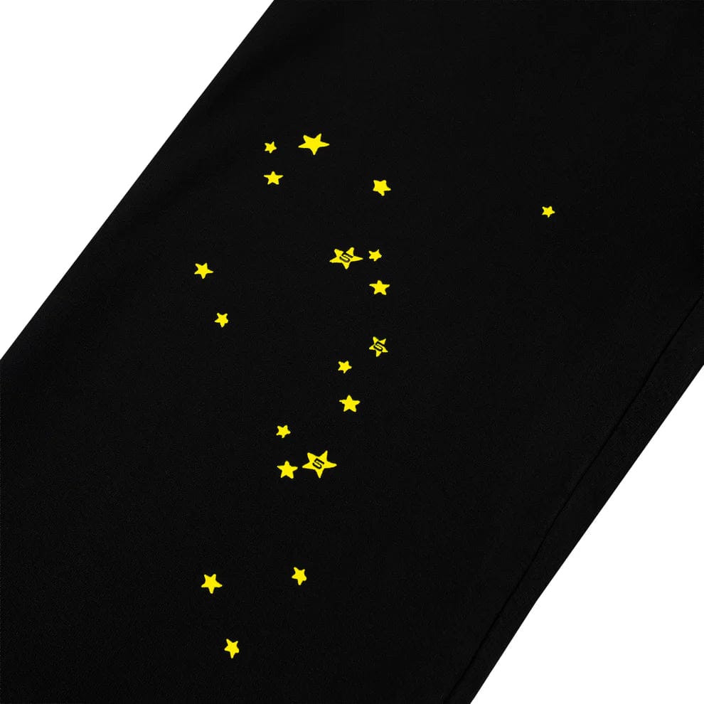 Sp5der Sweatpants – Unisex black cotton sweatpants featuring a flame side logo and scattered yellow star print, perfect for adding a bold, celestial touch to any streetwear look.
