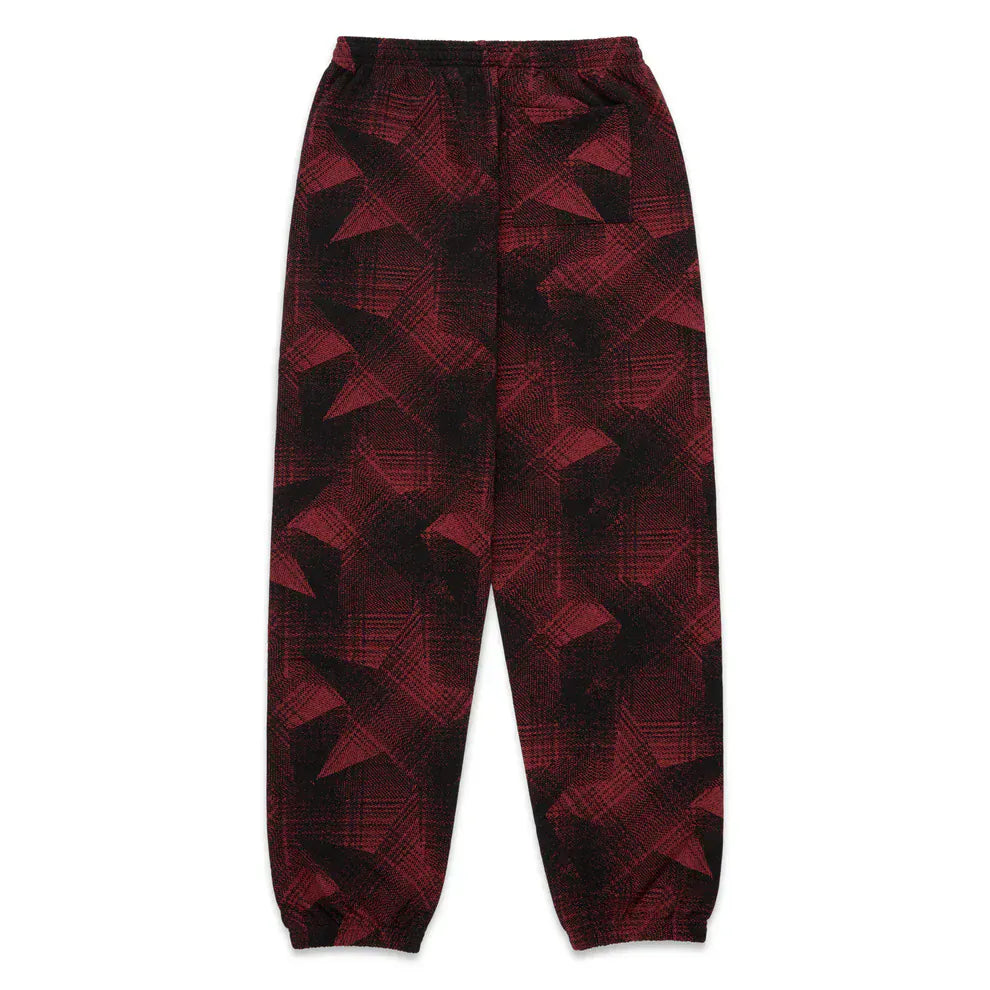 Sp5der Sweatpants – Unisex red and black patterned cotton joggers with graphic detail, elastic waistband, and cuffs. Bold streetwear style laid flat on a white background.