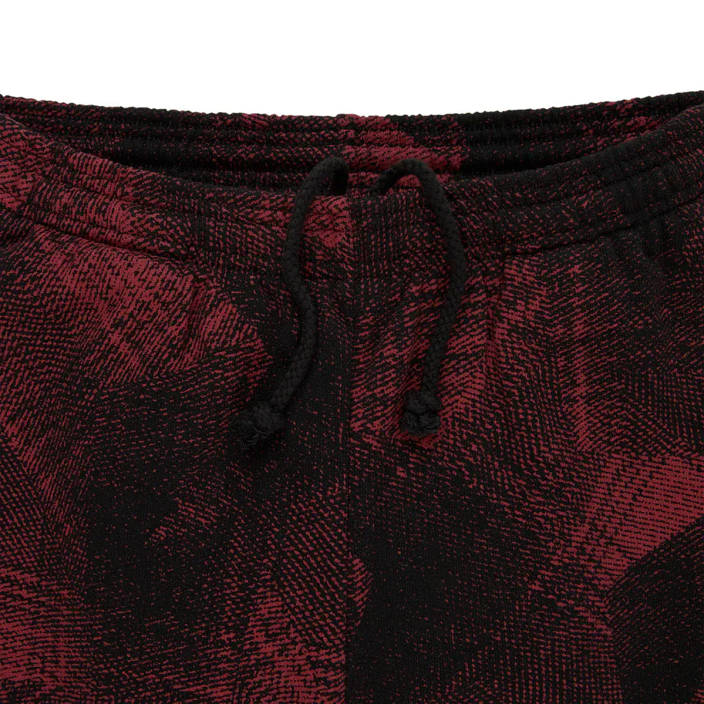 Close-up of the waistband and drawstring on Sp5der Sweatpants – Unisex Red and Black Patterned Cotton Sweatpants with graphic detail, highlighting their bold textured look for streetwear jogger fans.