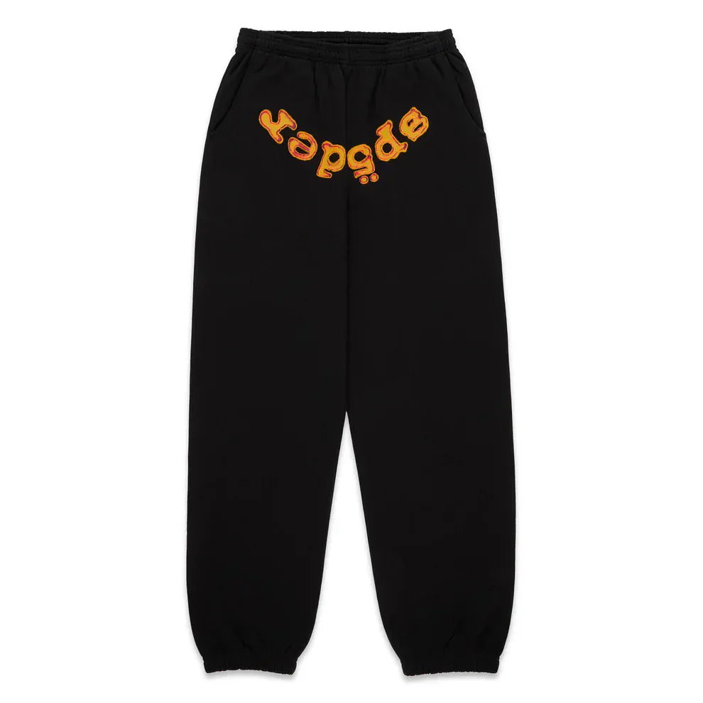 Unisex Sp5der Sweatpants in black cotton, featuring an elastic waistband and cuffs with a flame front logo print.