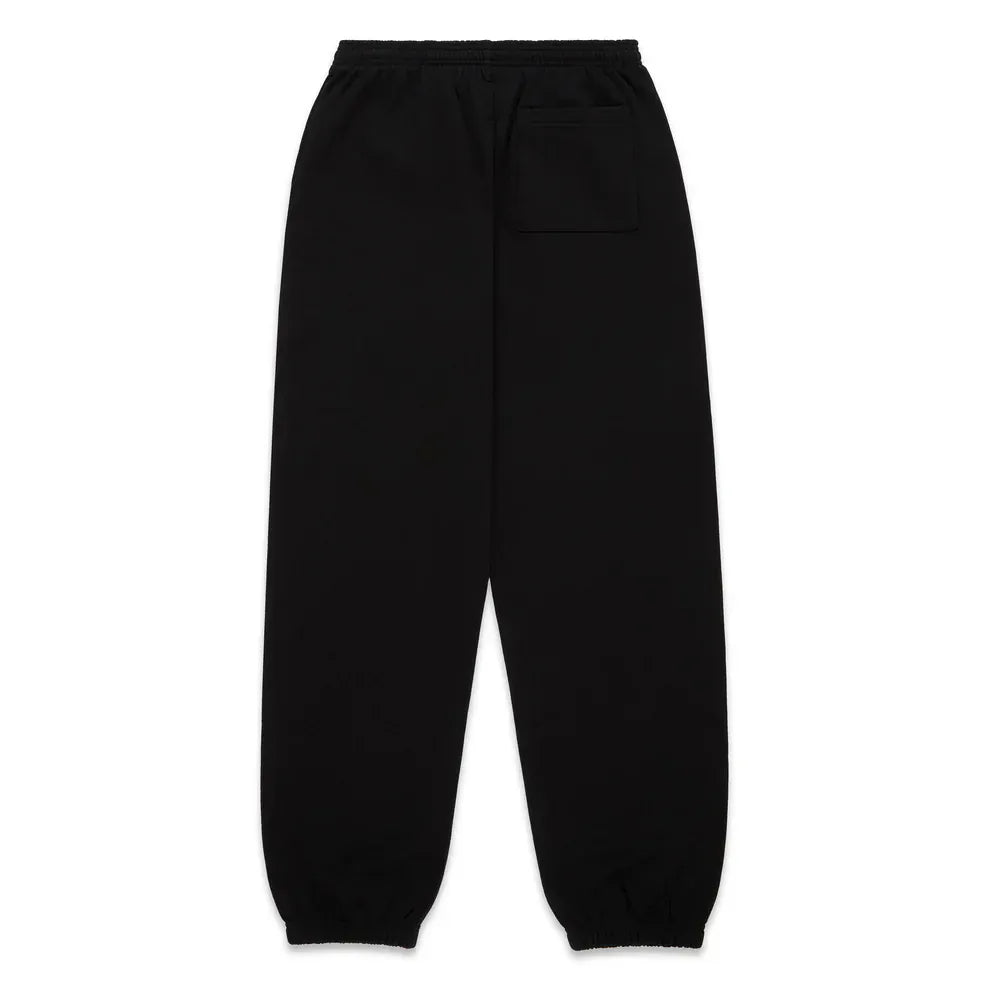 Unisex Sp5der Sweatpants in black cotton with a flame front logo print, elastic waistband and cuffs, and a single back pocket. Shown laid flat, back side up to highlight the minimalist design.