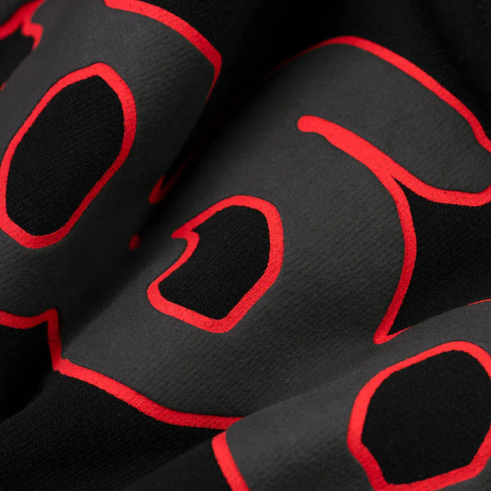 Close-up of the Sp5der 440GSM Heavyweight Star Hoodie – Black & Grey Oversized Streetwear Pullover, showcasing its bold, red-outlined graphics and textured heavyweight fleece fabric for a premium urban look.