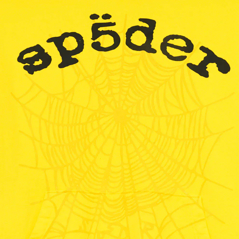 The image features the Yellow Graphic Hoodie with Spider Web Print and Lettering—a comfort fit pullover hoodie with bold black "spīder" text above a subtle web design on a vibrant yellow background, ideal for standout streetwear style.