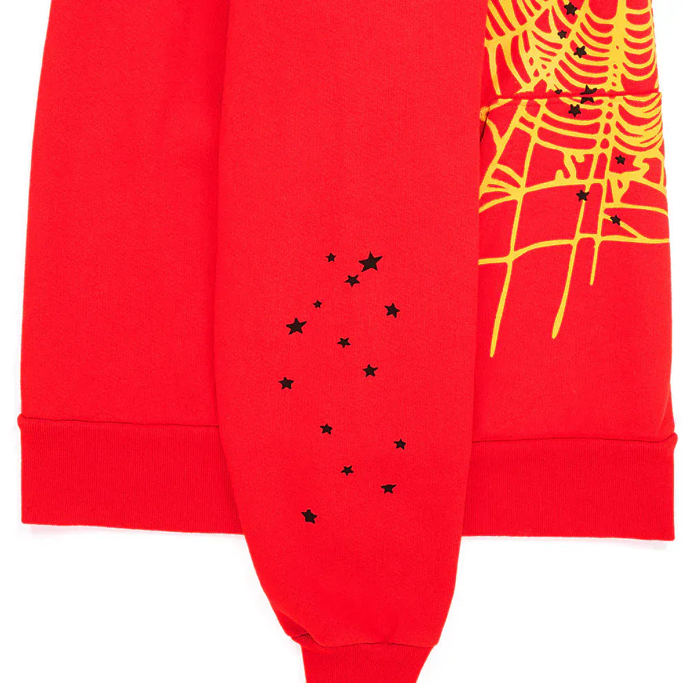 The Red Graphic Hoodie with Spider Web Print and Star Details is a comfort fit pullover featuring a yellow spiderweb and black star accents—ideal streetwear for standout style.