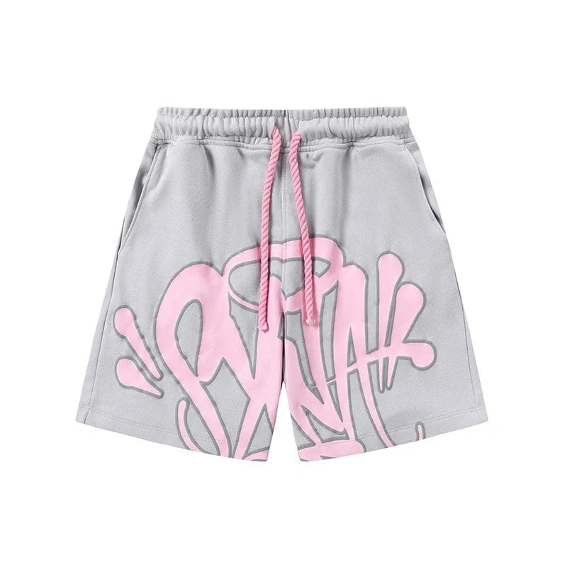 The Syna World Grey Pink Graffiti Graphic Print Sweat Shorts feature an elastic waistband, pink drawstring, and bold pink graffiti graphics on premium fleece for a standout streetwear look.