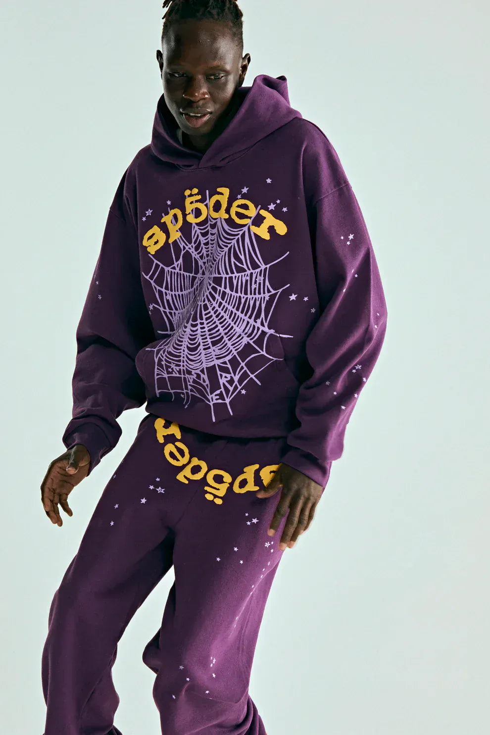 Someone models the Sp5der Web Hoodie – Deep Purple & Yellow 440GSM Heavyweight Oversized Streetwear Pullover with matching sweatpants, featuring a bold yellow "sp5der" logo, highlighting luxury Y2K-inspired streetwear style.