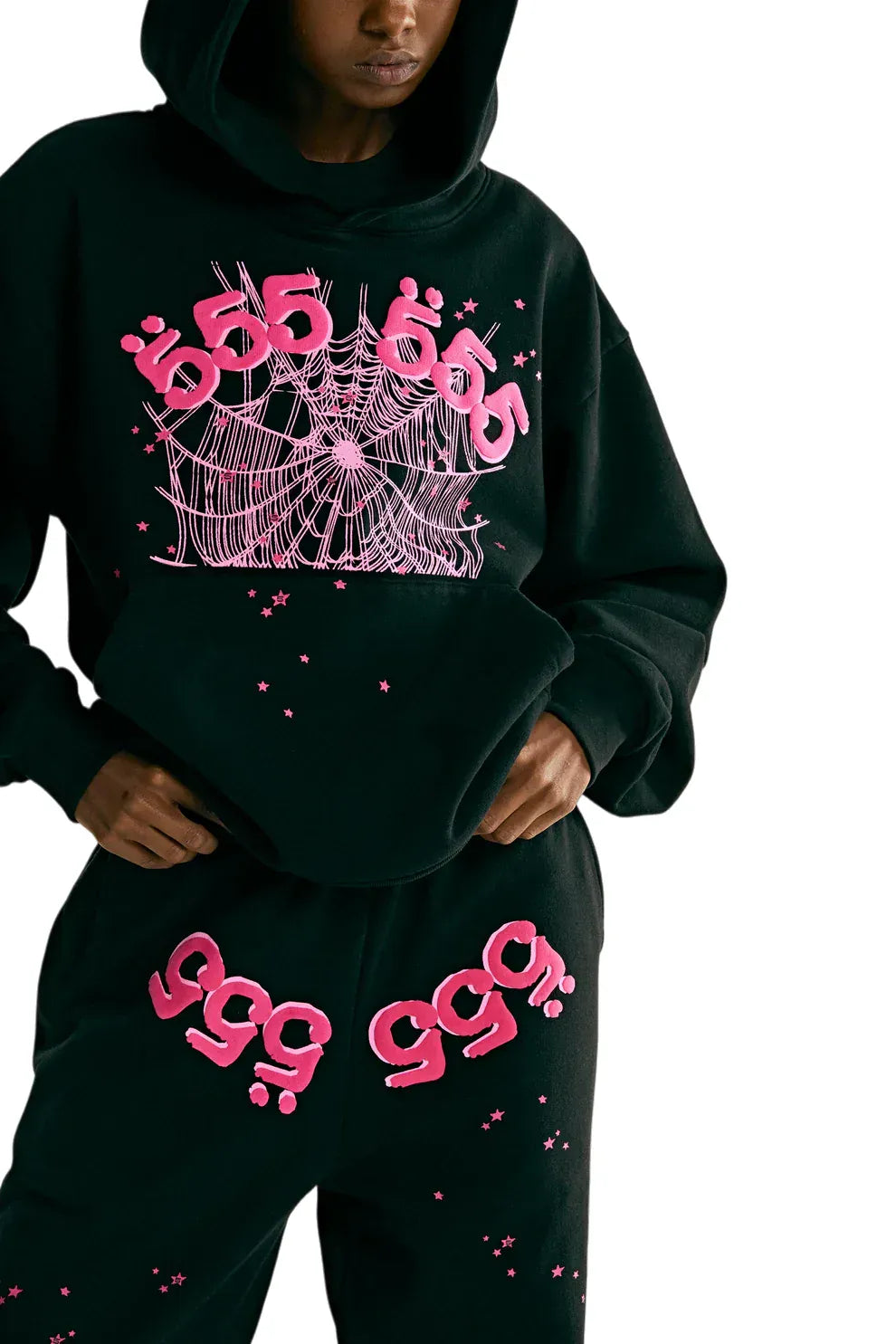 Person wearing a Sp5der 555 Hoodie – Black & Pink Web 440GSM Heavyweight Streetwear Pullover and matching sweatpants with bright pink web graphics, dot designs, large 555s on the hoodie, and multiple 999s on the pants.