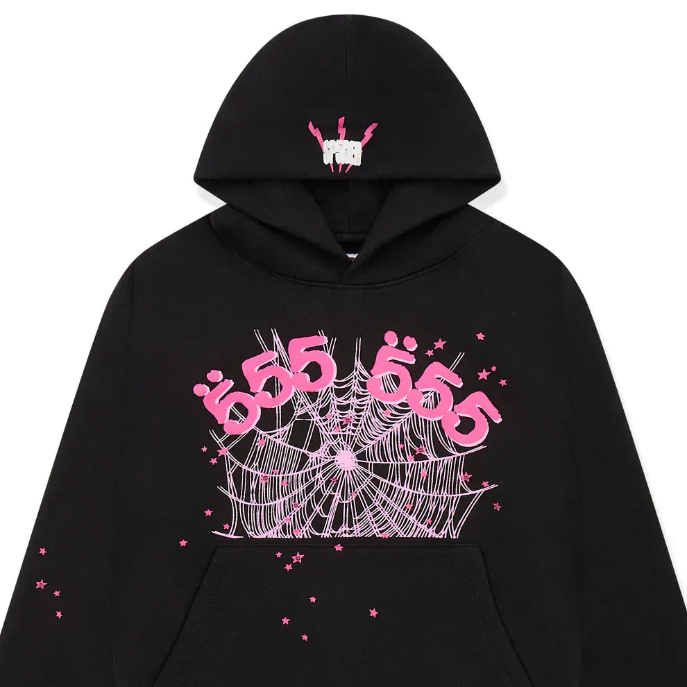 The Sp5der 555 Hoodie – Black & Pink Web features pink "555" text, spiderweb and star graphics on the front, plus a hand gesture design on the hood. Embrace Y2K style with this 440GSM heavyweight streetwear pullover.